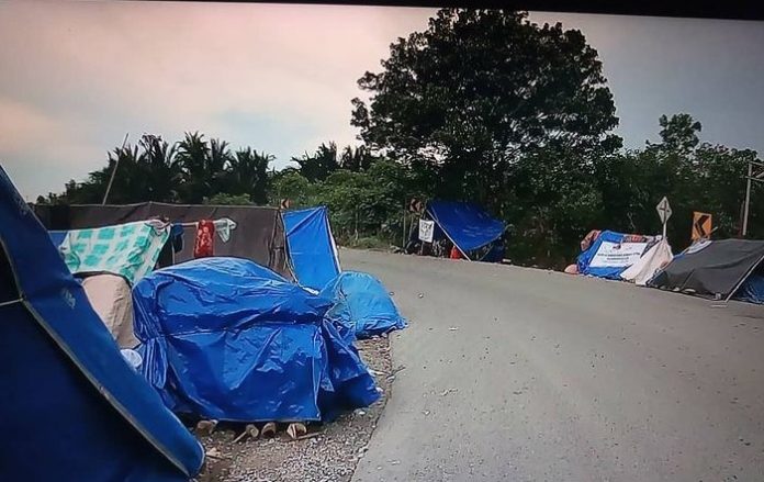 Tenda pengungsian warga Desa Paku Alam, Kecamatan Sungai Tabuk, Kabupaten Banjar, yang didirikan di tepi Jalan Gubernur Syarkawi. (IG @wargabanua)