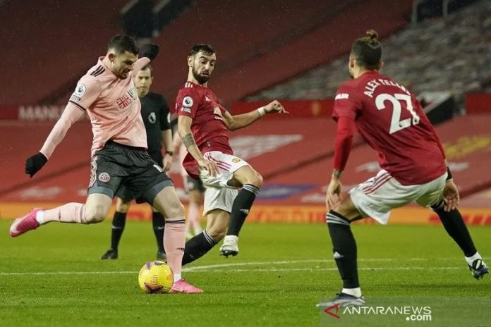 Penyerang Sheffield United Oliver Burke (kiri) melepaskan tembakan untuk mencetak gol kedua timnya ke gawang Manchester United dalam lanjutan Liga Inggris di Stadion Old Trafford, Manchester, Inggris, Rabu (27/1/2021) waktu setempat. (ANTARA/REUTERS/POOL/Tim Keeton)