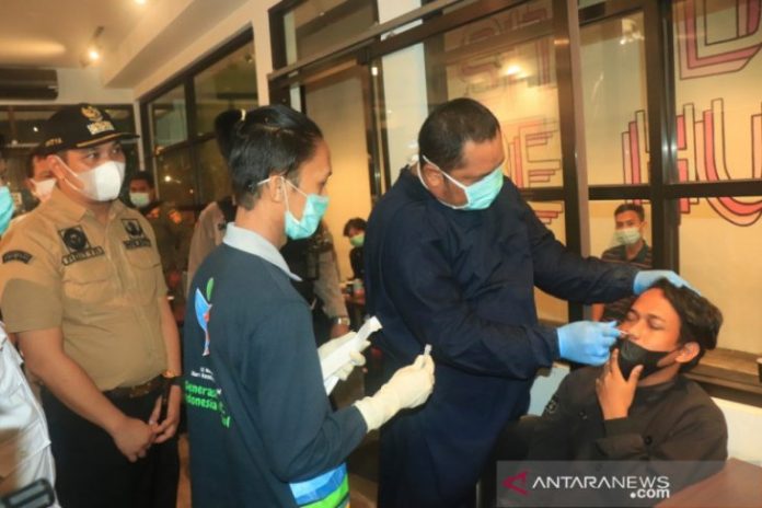 Wali Kota Banjarbaru HM Aditya Mufti Ariffin (paling kiri) menyaksikan satu petugas melakukan rapid antigen kepada salah seorang pengunjung cafe saat patroli PPKM Mikro digelar, Sabtu malam. Foto humas/Antaranews Kalsel