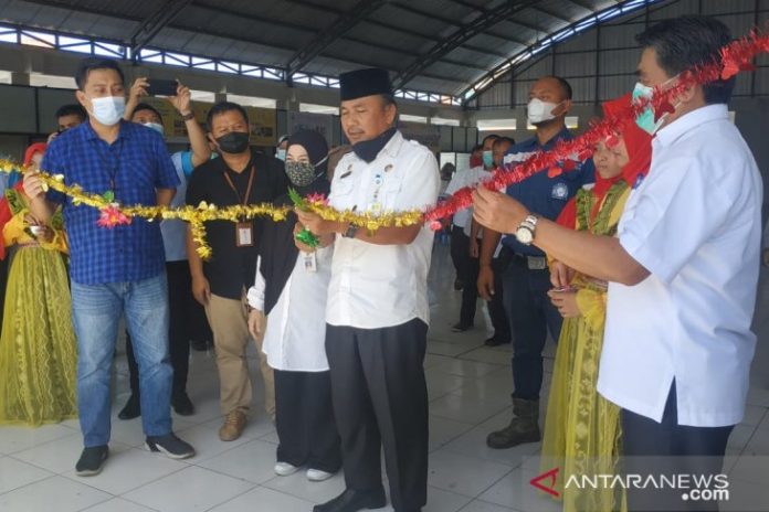 Plt. Kepala Dinas Koperasi, Perindustrian dan Perdagangan, Murdiyanto menggunting pita menandai diresmikanya lapak UMKM di Pasar Kemakmuran Kotabaru (Antaranews Kalsel/ohi/humas)