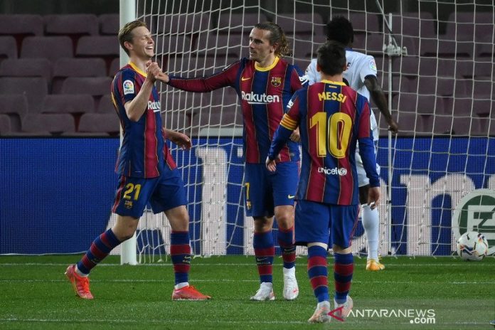 Penyerang Barcelona Antoine Griezmann (tengah) melakukan selebrasi dengan rekan setimnya setelah mencetak gol dalam pertandingan Liga Spanyol lawan Getafe di Camp Nou pada 23 April 2021. (AFP/LLUIS GENE)