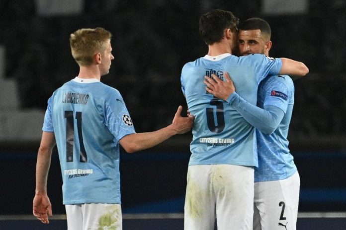 Gelandang Manchester City Oleksandr Zinchenko dan rekannya bek Ruben Dias dan bek Kyle Walker setelah memenangkan leg pertama semifinal Liga Champions melawan Paris Saint-Germain di Parc des Princes di Paris, 28 April 2021.(AFP/ANNE-CHRISTINE POUJOULAT)