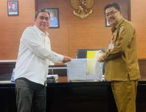 Ketua PWI Kalsel, Zainal Helmie, menyerahkan laporan penyelenggaraan HPN 2025 kepada Kadis Kominfo Kalsel, HM Muslim, Selasa. (wartabanjar.com - Ist. Humas PWI Kalsel)