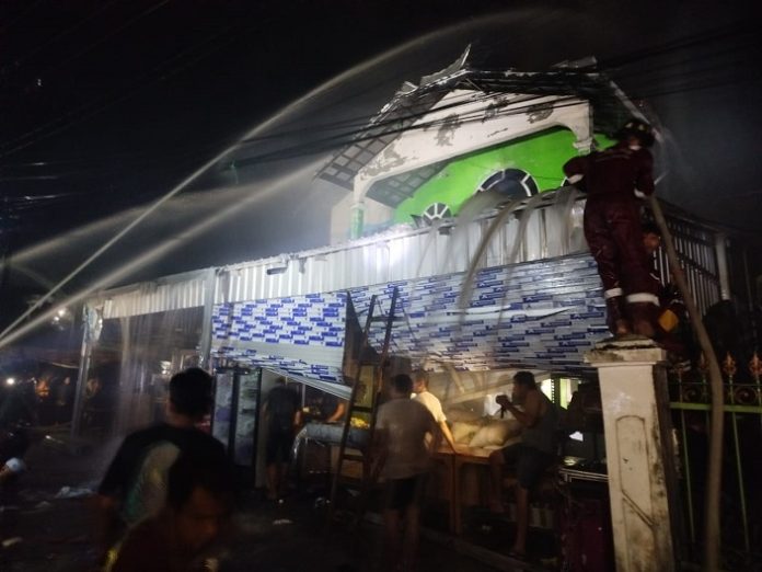 Tim Damkar gabungan Kota Banjarmasin melakukan pembasahan rumah yang terbakar Komplek Semanda, Selasa. (wartabanjar.com - Ramadan Anwar)